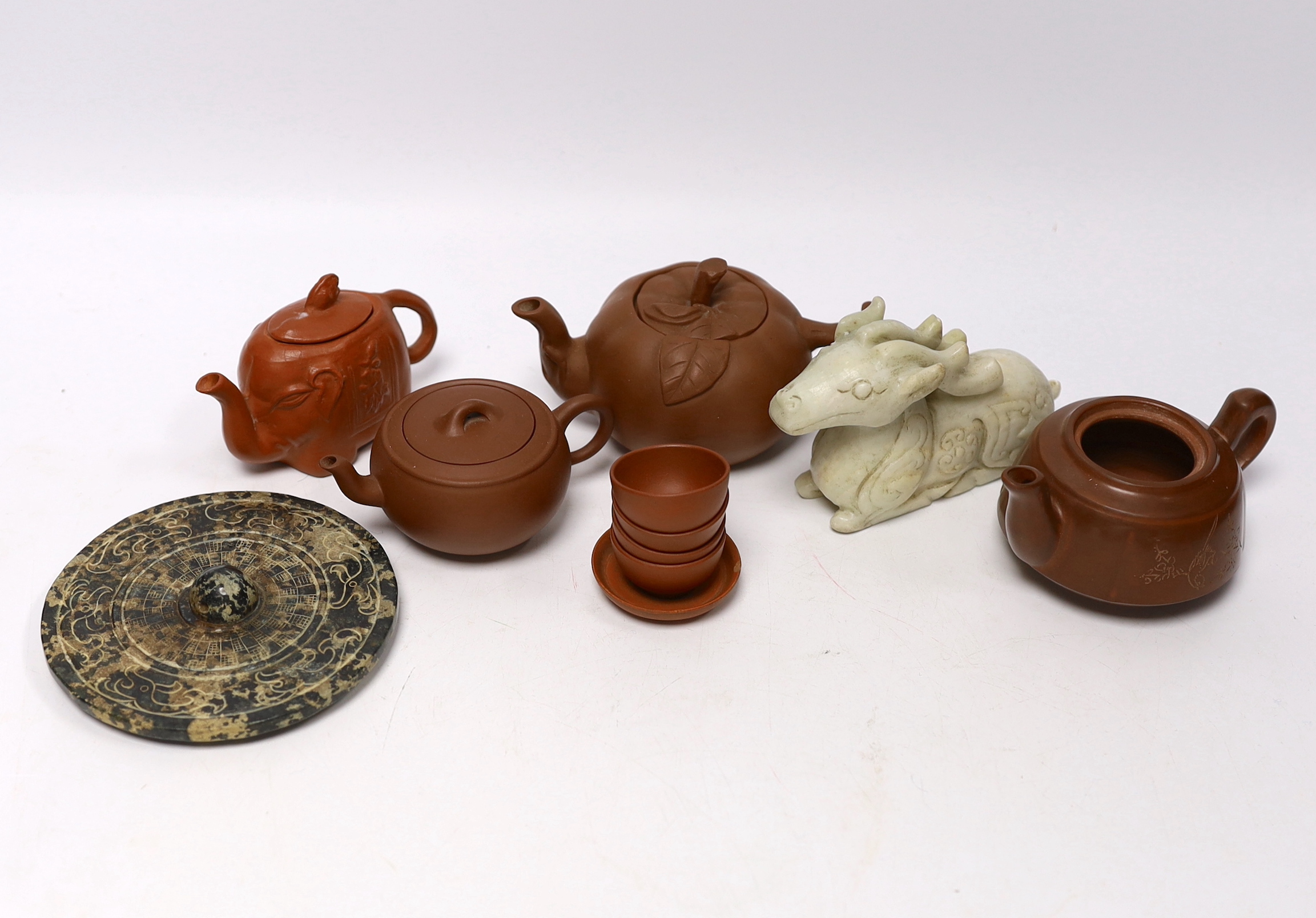 Eleven Chinese items including four Yixing pottery teapots, a stone disc, a jade horse and five miniature bowls, tallest teapot 6.5cm
